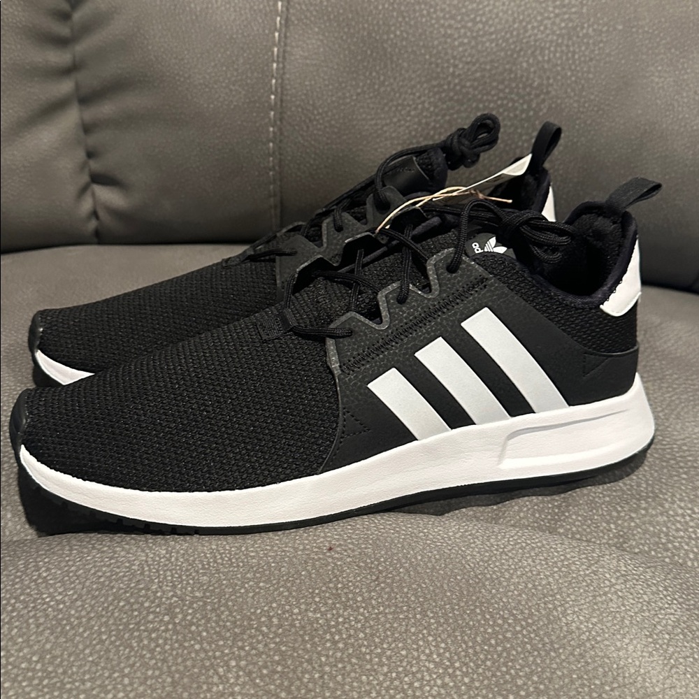 NWT Adidas basketball shoe.